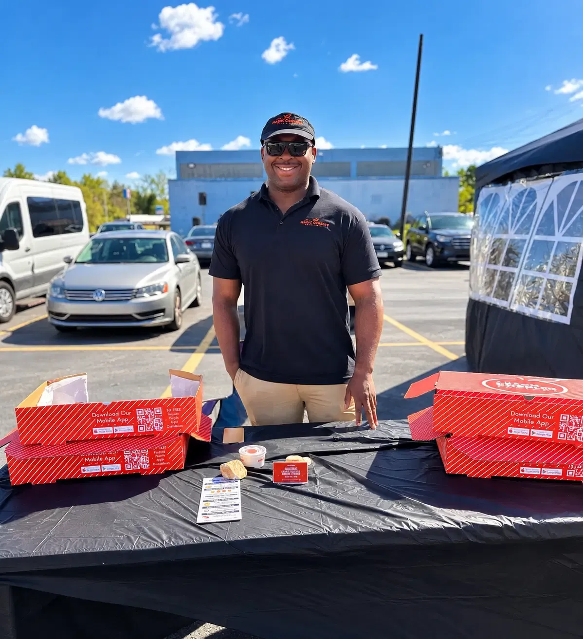 A local vendor shares food and information at an outdoor festival table.