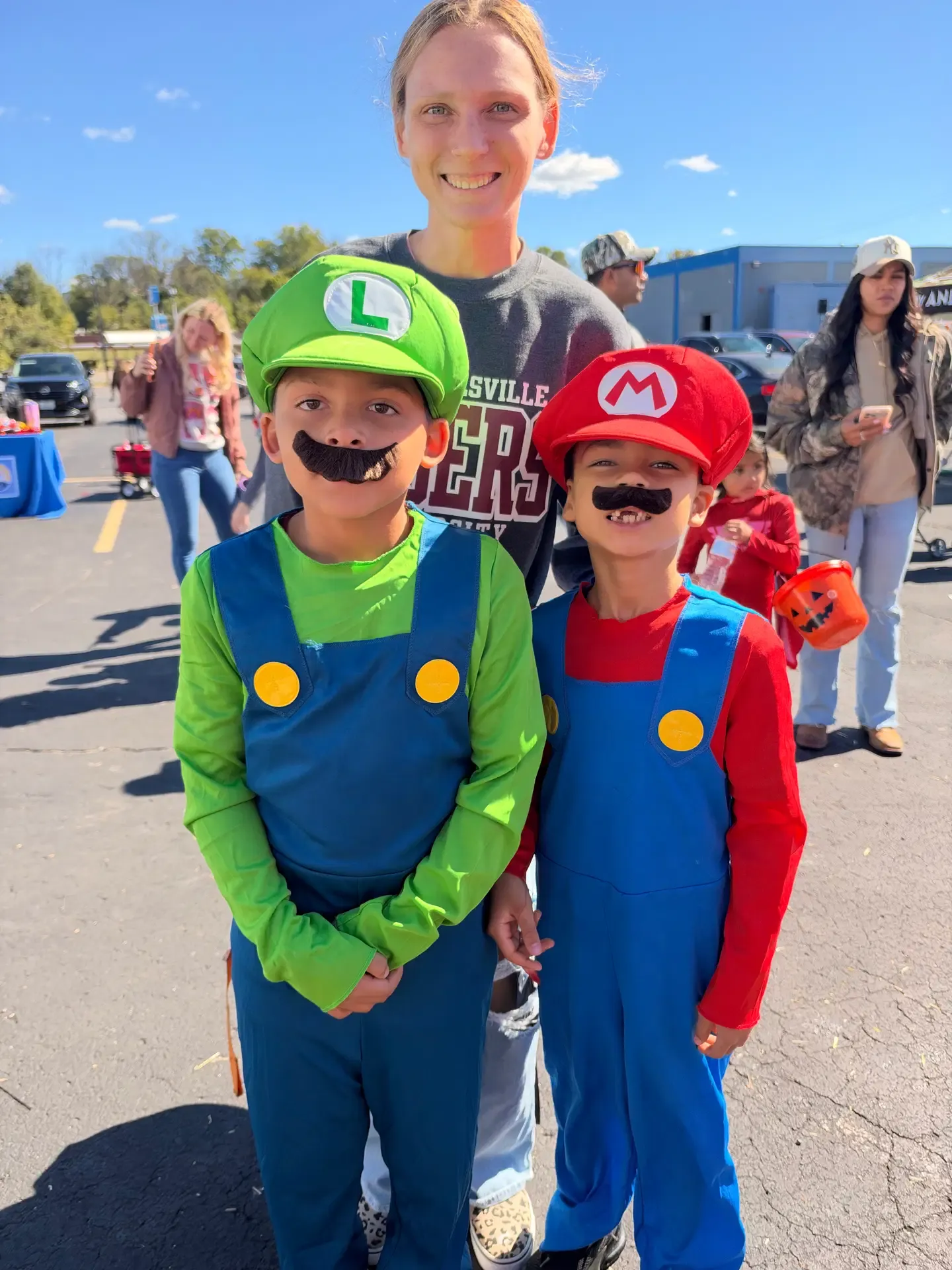 Two children in colorful costumes pose at the festival.