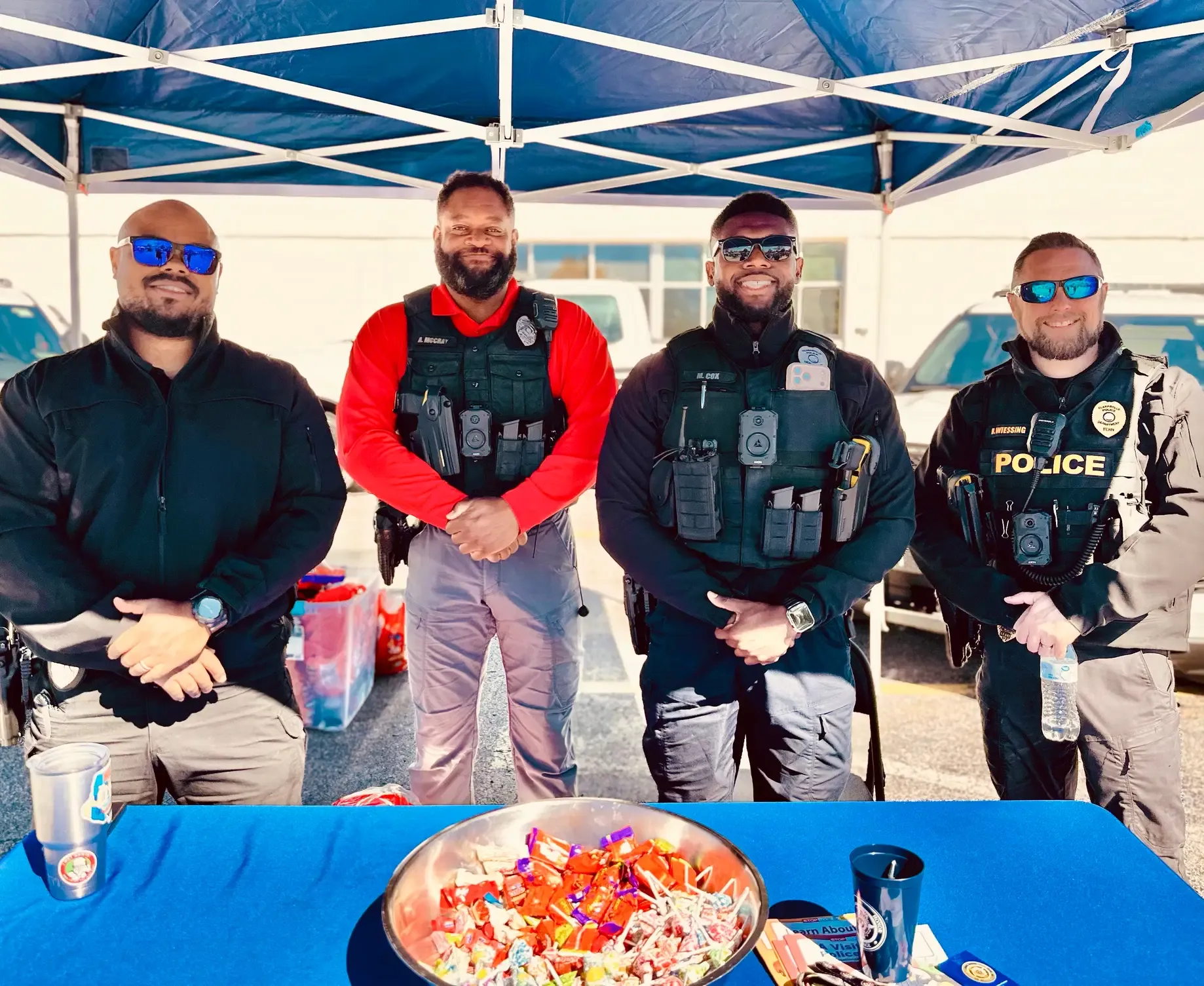 Clarksville public-safety officers greet visitors beneath a blue canopy.