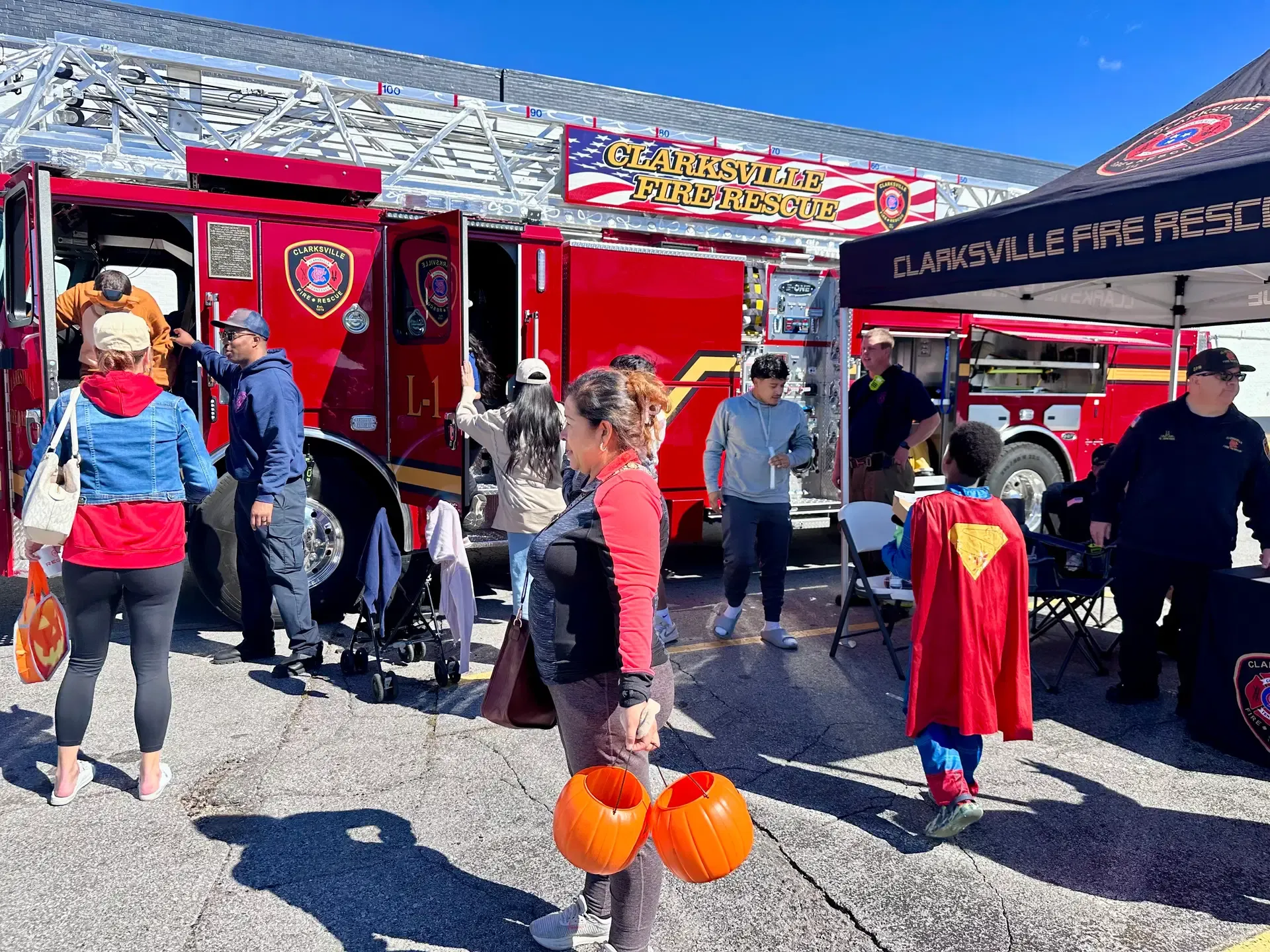 Families and community partners gather around a Clarksville Fire Rescue display at the Fall Safety Festival.