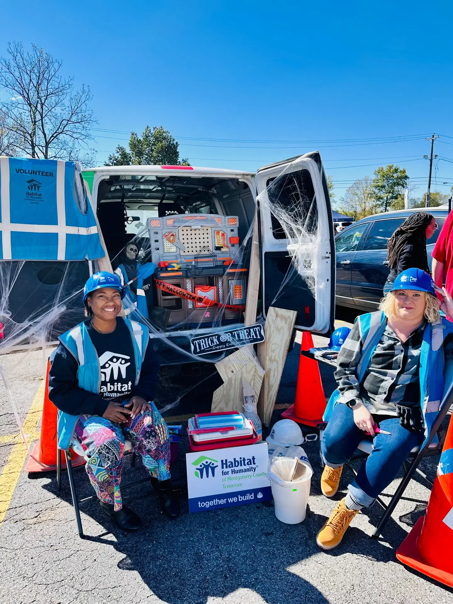 Habitat for Humanity volunteers host a decorated trunk-or-treat display.