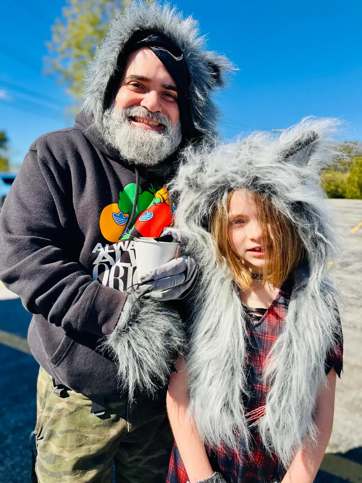 A father and child pose together in animal costumes at the festival.