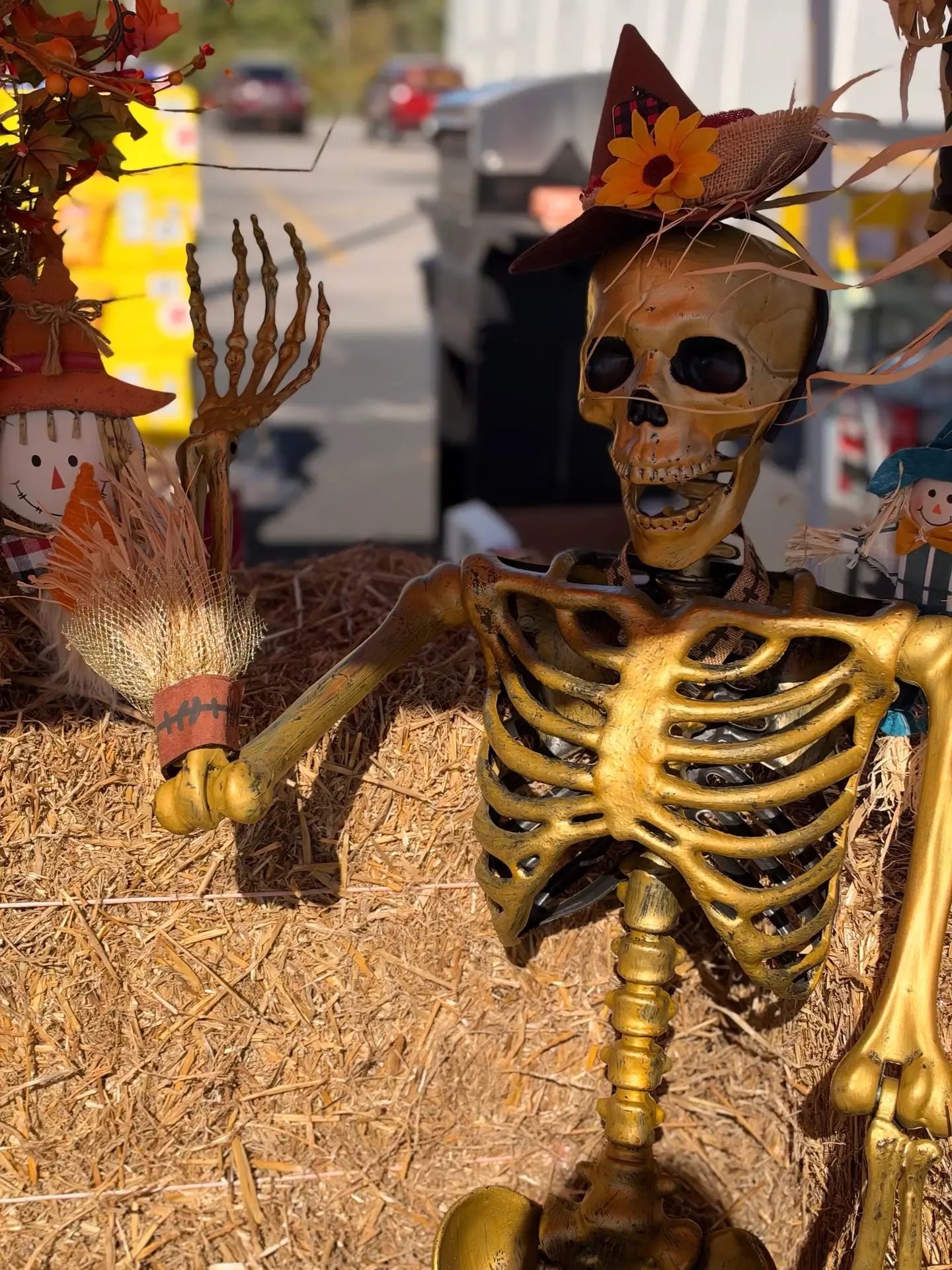 A child takes part in a festival activity with family nearby.