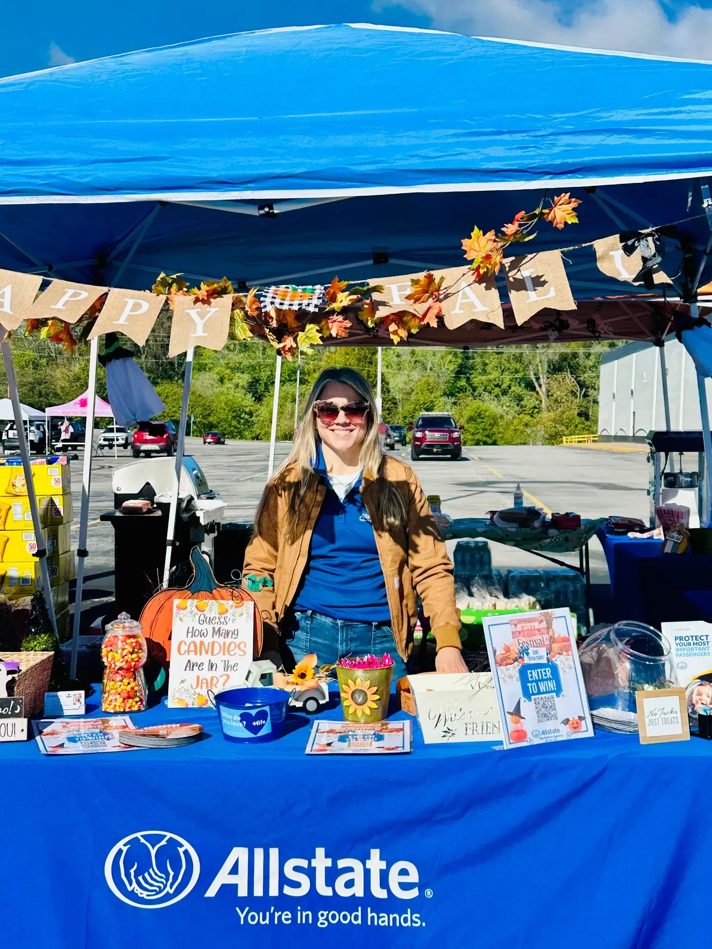 A family gathers around an autumn-themed festival display.
