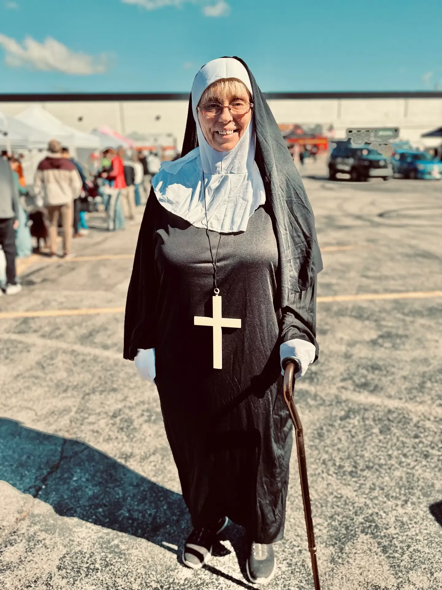 A festival guest in a nun costume smiles at the event.