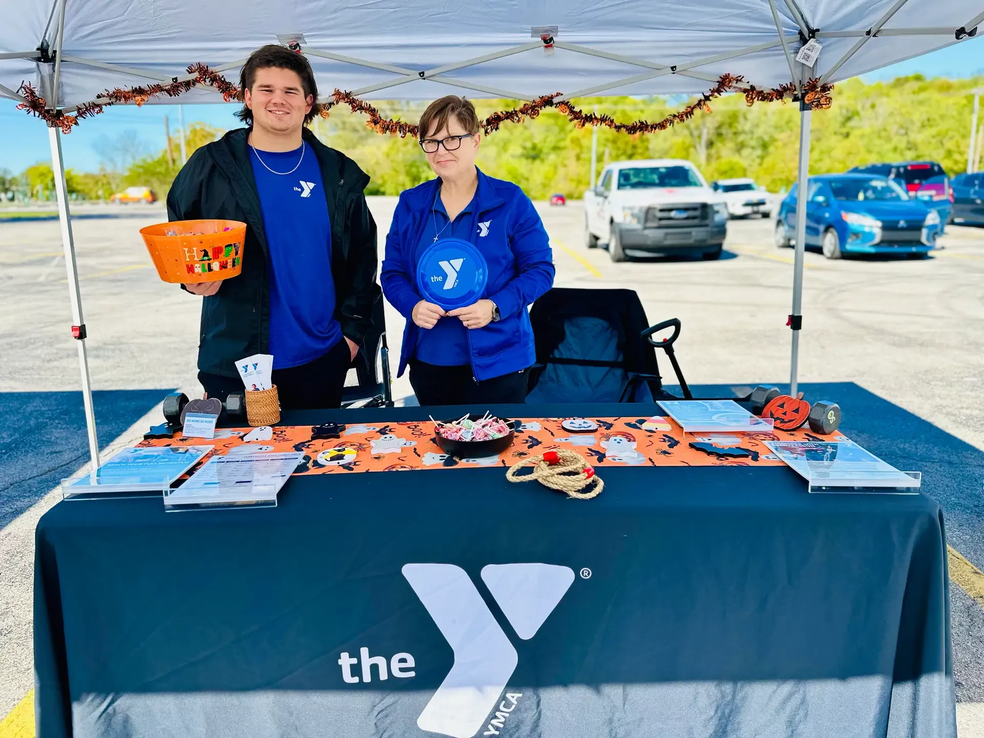 YMCA representatives host a decorated family-friendly festival table.