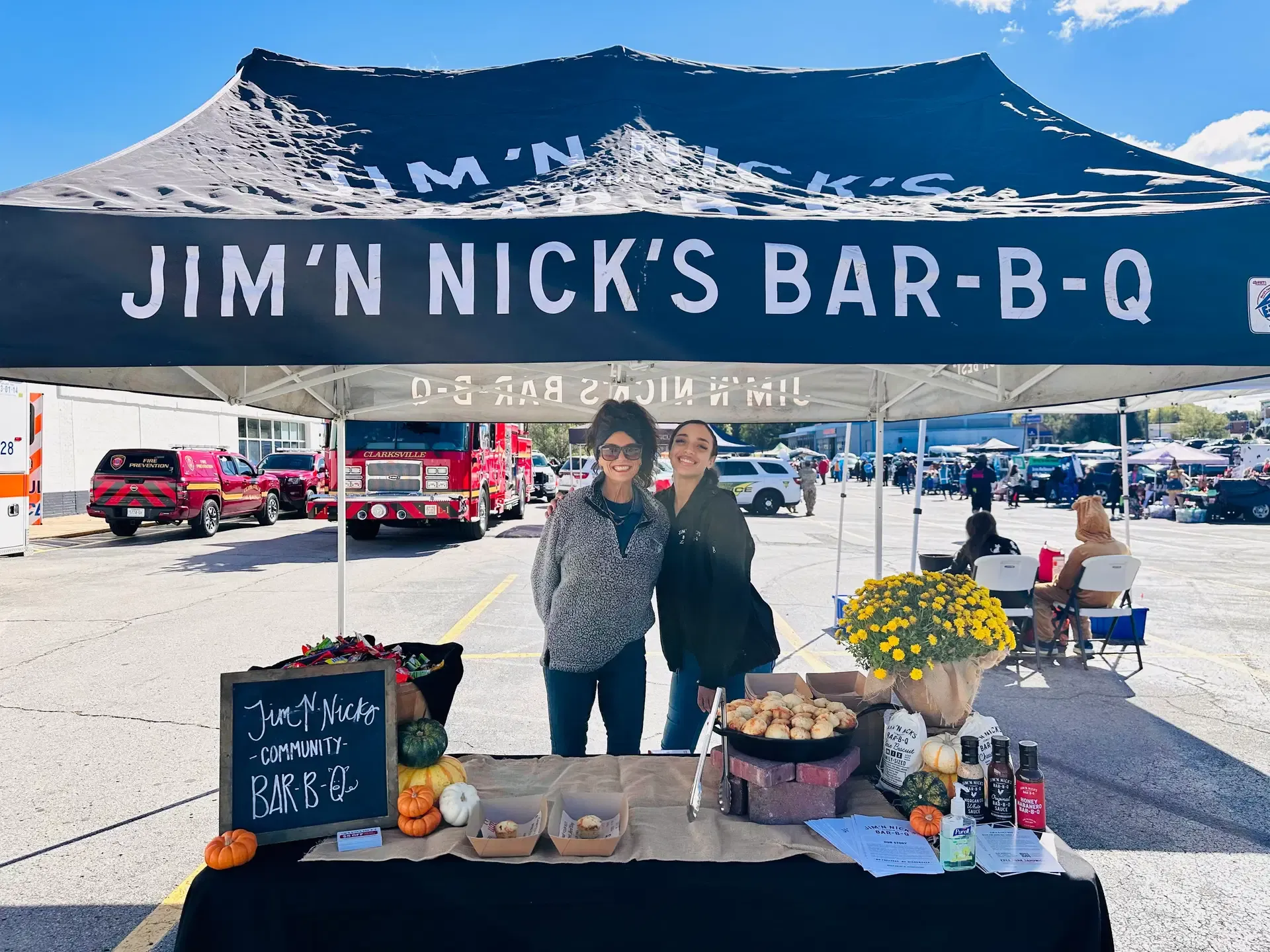 Jim ’N Nick’s Bar-B-Q representatives welcome guests at their festival booth.