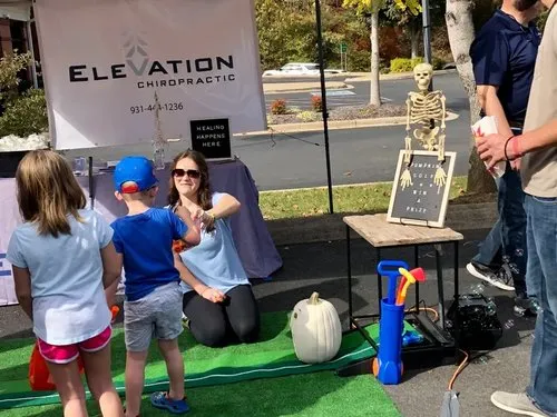 Children playing a festival game at a community booth