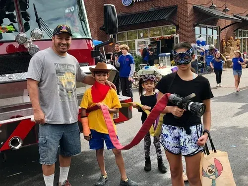 Children in costumes enjoying the outdoor Fall Safety Festival