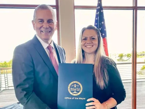 Agency Owner, Alexis Goines receiving a city proclamation from Clarksville’s Mayor, Joe Pitts on behalf of the National Association of Insurance and Financial Advisors to declare September as Life Insurance Awareness Month.