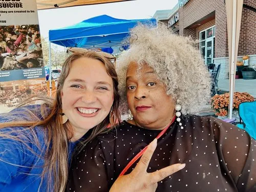 Jami Joynor with a community member at an outdoor event
